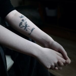 a person with a flower tattoo on their arm